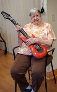 Old lady holding a guitar