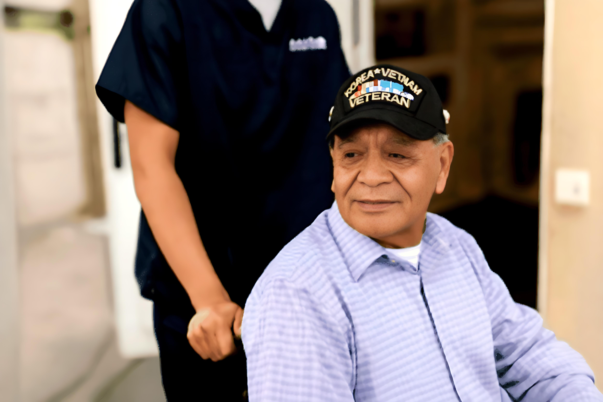 Veteran Being Pushed in a wheel chair by a Cantata Caregiver
