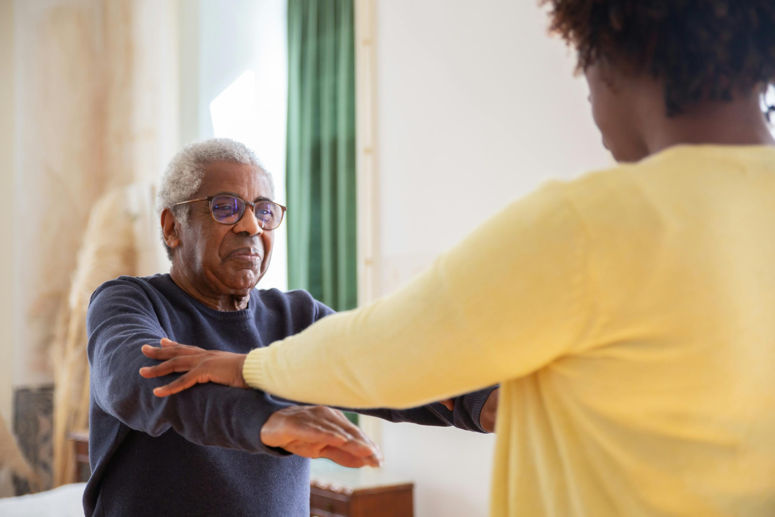 Doctor Helping Senior with Getting Up